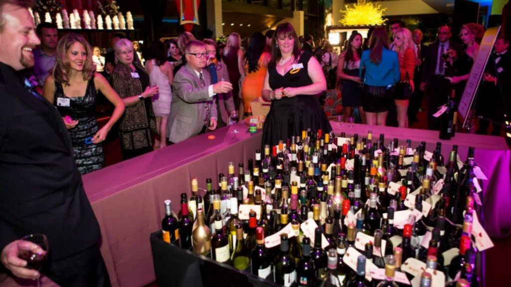 Guests participating in interactive fundraising activities at a gala event